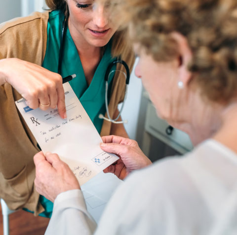 doctor-giving-a-prescription-to-senior-patient-1600x1439