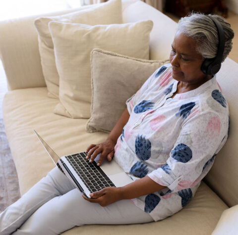 senior-african-american-woman-sitting-on-sofa-wear-1600x1439