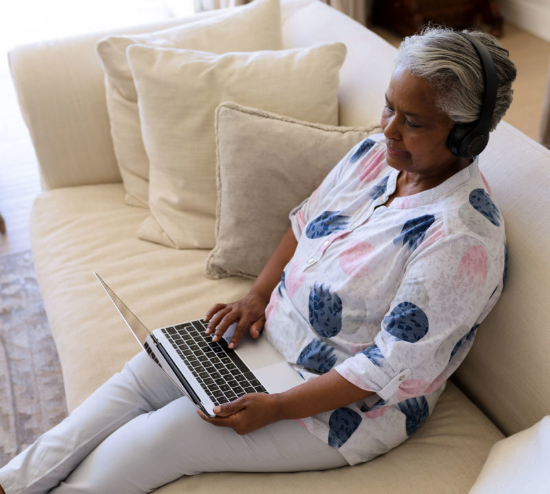 senior-african-american-woman-sitting-on-sofa-wear-1600x1439