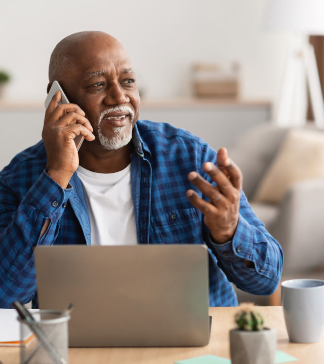 senior-african-businessman-talking-on-phone-sittin-1600x1439